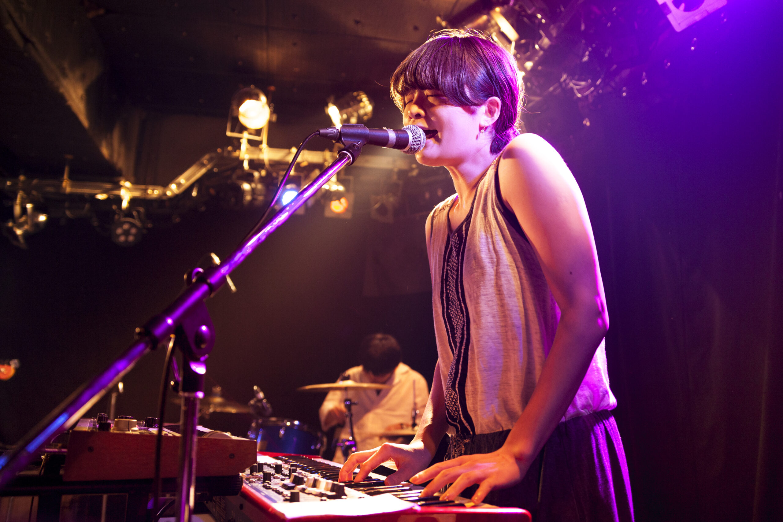 indie musician playing keyboard at live event